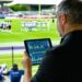 A 20coach 20analyzing 20data 20on 20a 20tablet 20while 20overlooki